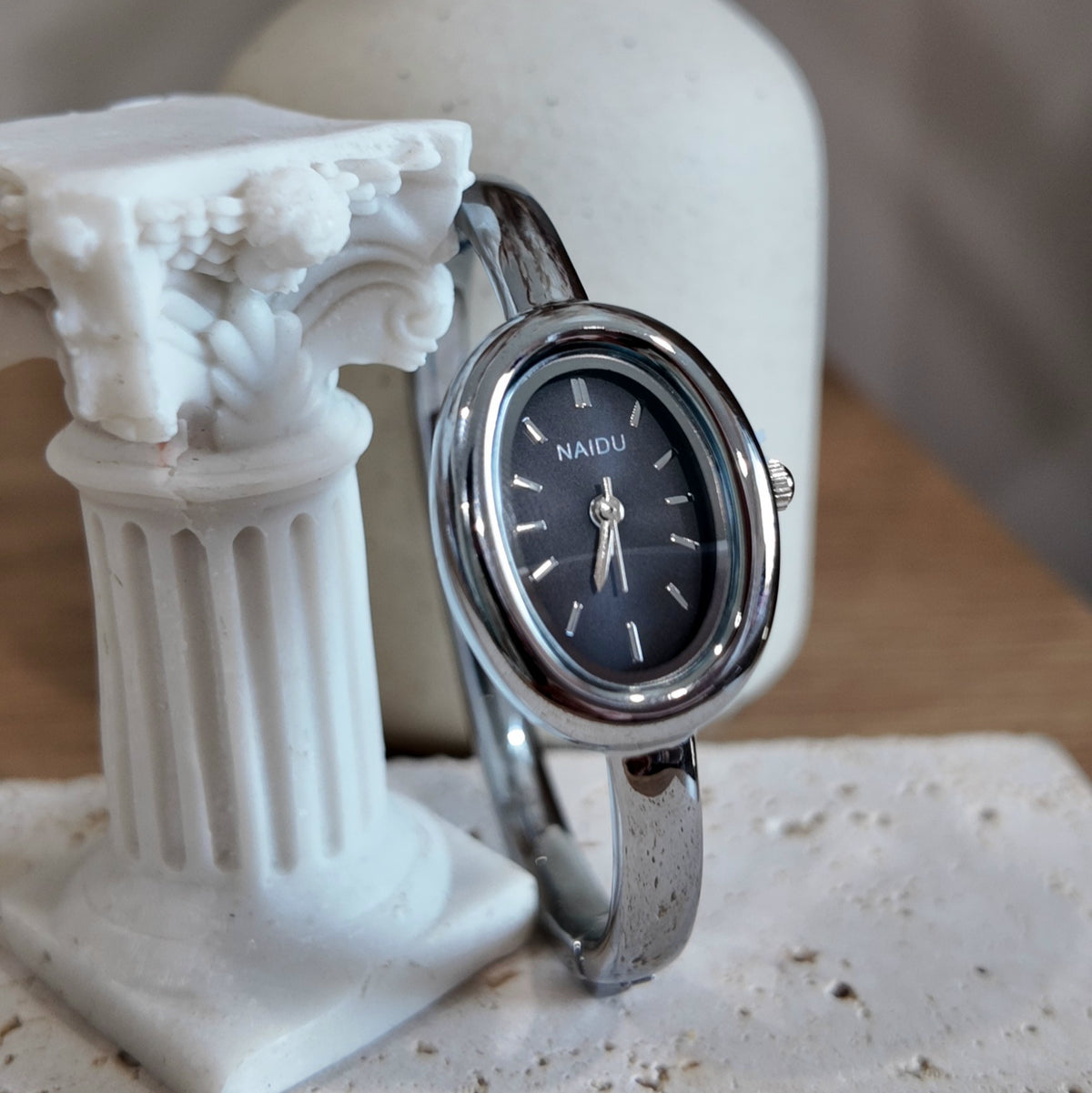Silver with black dial bangle watch